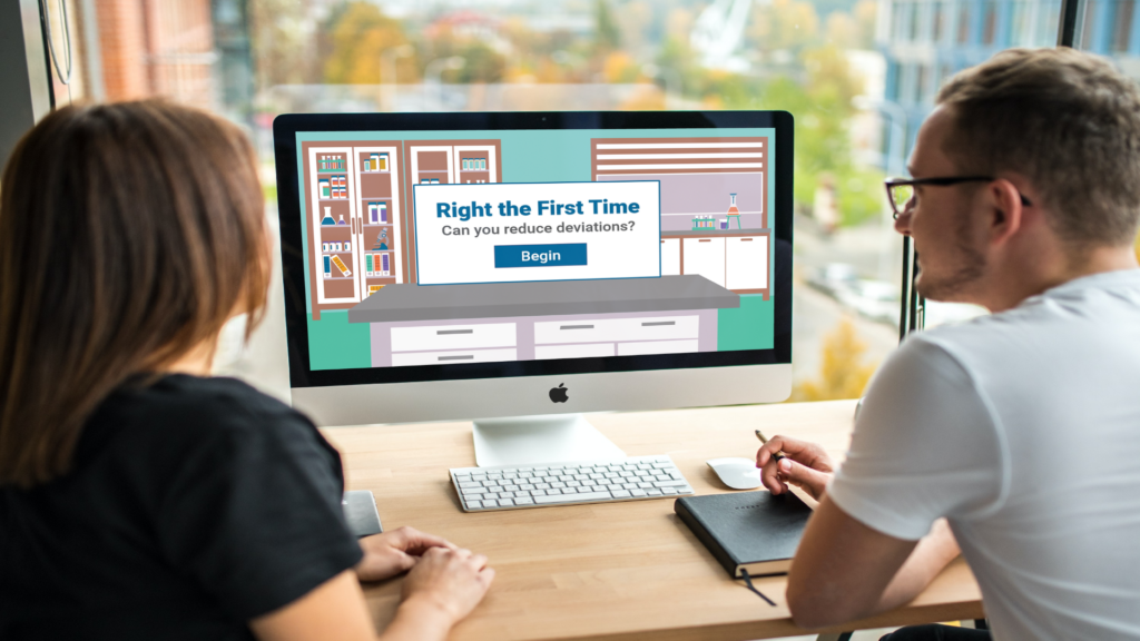 two people working at a desk with a computer showing the title screen for the "Right the First Time" eLearning